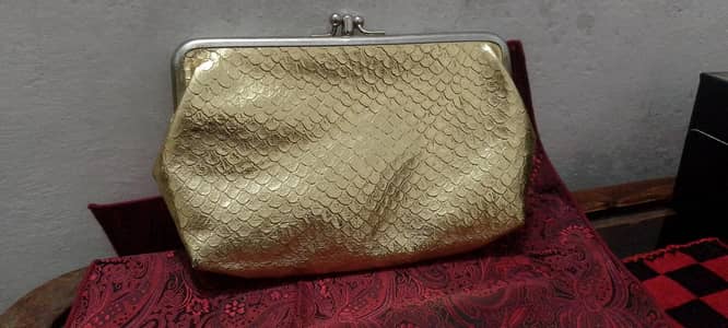golden colour shiny clutch