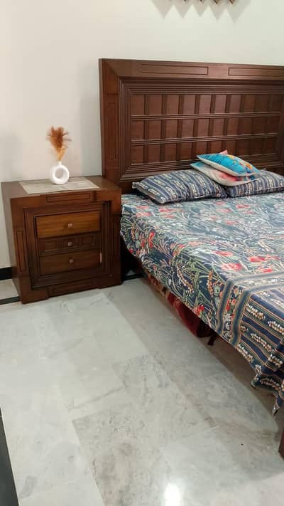 wooden bed without mattress with both of sidetables