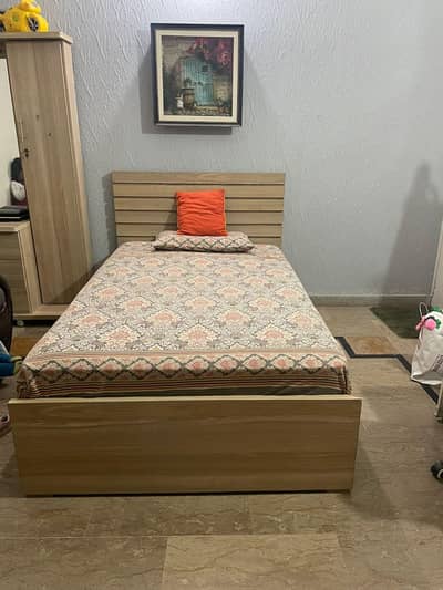 bed with dressing and cupboard