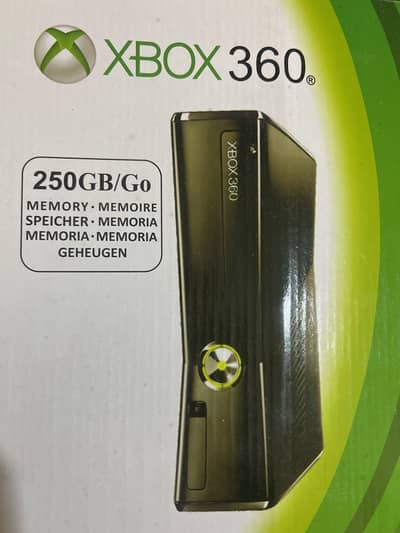 Xbox with box and two wireless controllers.