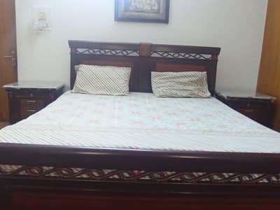 Double bed without mattress with side tables and dressing table