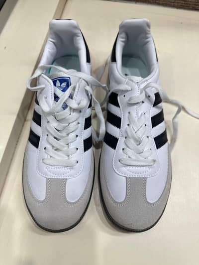 White adidas samba with black strip