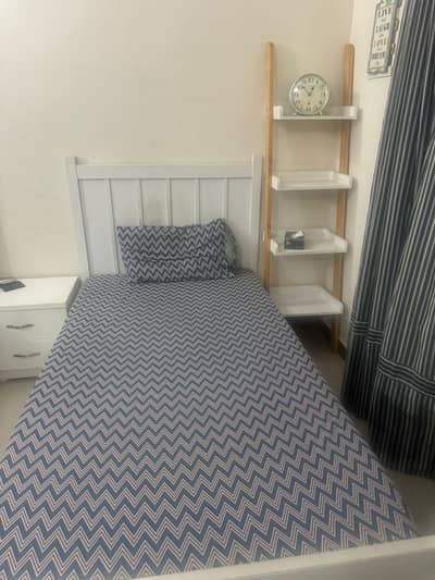 2 single beds with side tables and other tables