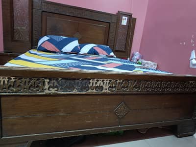 Wooden bed with side table and mattress