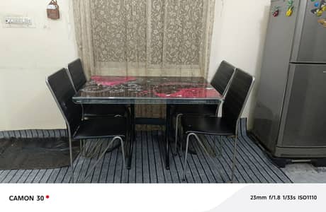 1 glass dining and 4 iron chairs. . .