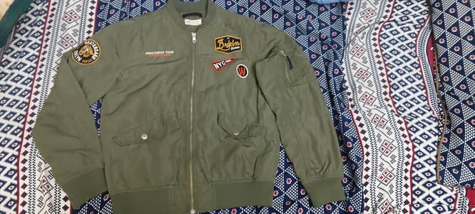 H&M olive green bomber jacket with patches.