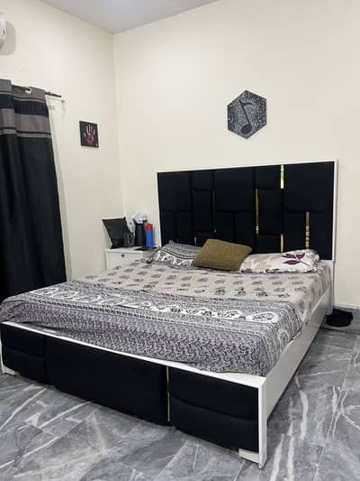 King sized black bed with cushioning plus Mattress and one side table