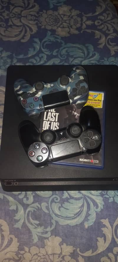 PS4 SLIM FOR SALE WITH BOTH CONTROLLERS AND GAME.