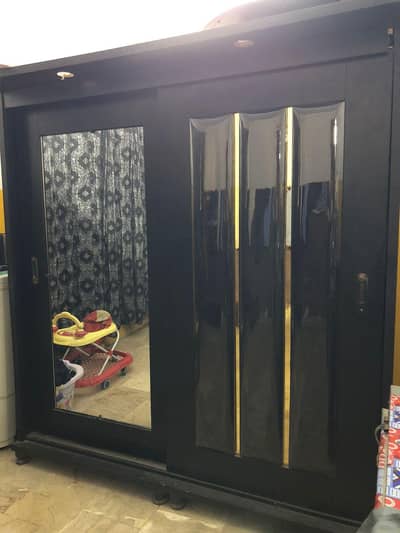 sliding almirah with mirror and cushions style.