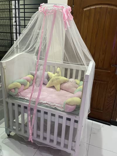 Baby cot with a comforter set and mattress