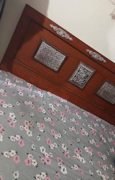 Wooden bed with mattress