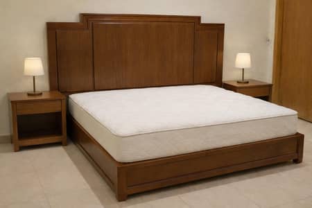 wooden bed with two side tables