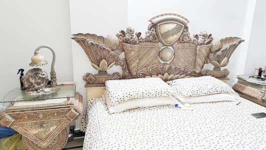 king size bed with side tables lamps and motifs