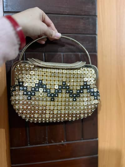 golden and black pouch style clutch