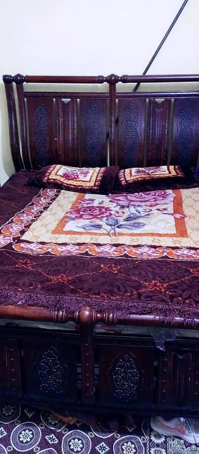 King bed with two side tables and a dressing table.