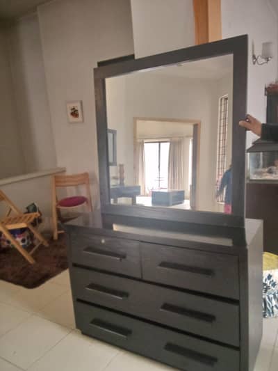 Dressing table with wall mounted mirror.