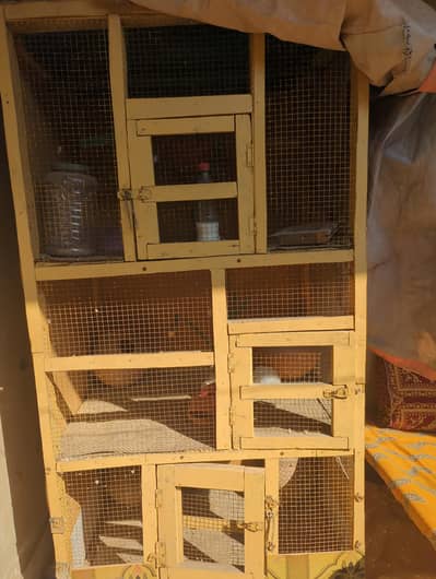 large wood cage or birds and other animals