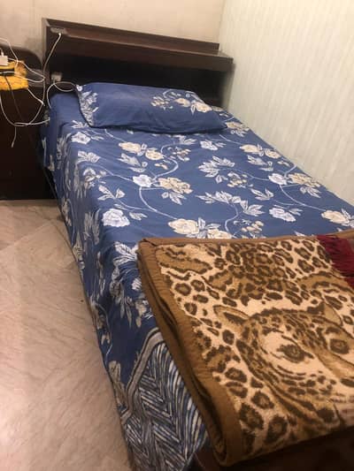 pair of wooden single beds