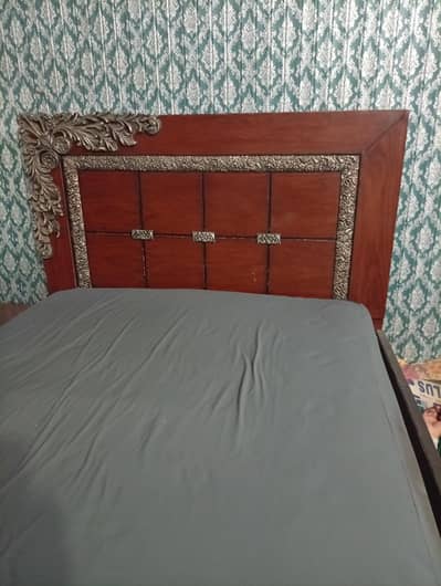 medium size wooden bed without mattress