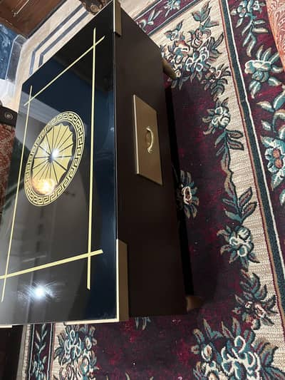 wooden center table dark brown with black glass with golden detail