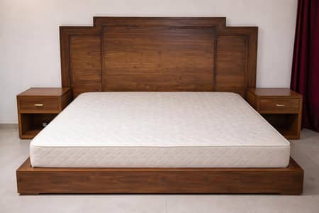 wooden bed with two side tables