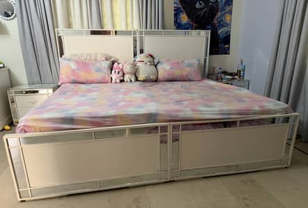 Two single white beds with side table