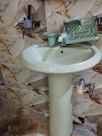 Wash basen with null and plastic sabun dani and mirror.