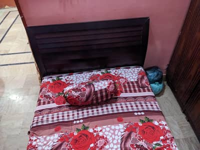Wooden bed with mattress