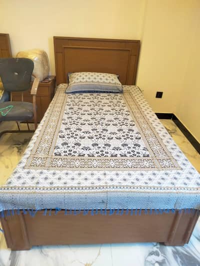 single bed with side table and matters