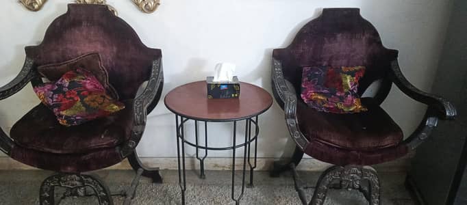 two chairs with center table