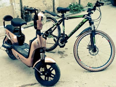 Electric scooty with free bicycle.