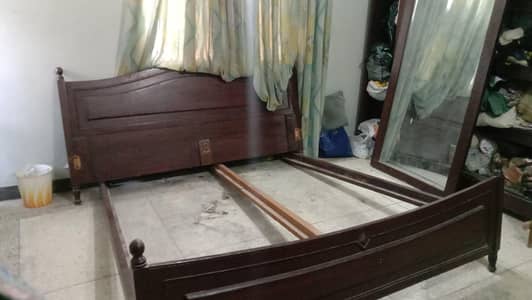 Wooden bed with cupboard