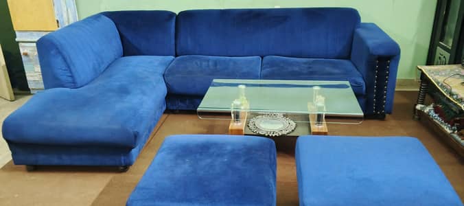 L shaped sofa with glass center table
