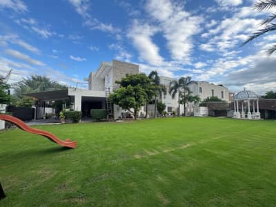 Corner 1 Kanal Lash Green Lawn + 2 Kanal Luxury Ultra-Modern Design Most Beautiful Full Basement Bungalow For Sale At Prime Location Of DHA Lahore Near To Park Masjid & Commercial Market.