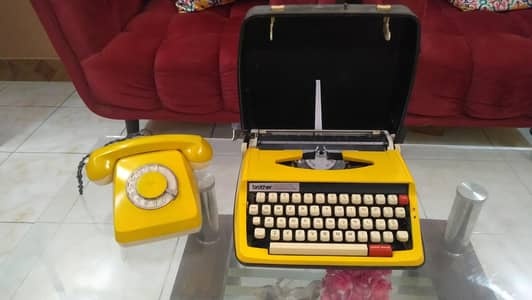 antique typewriter and dialer telephone