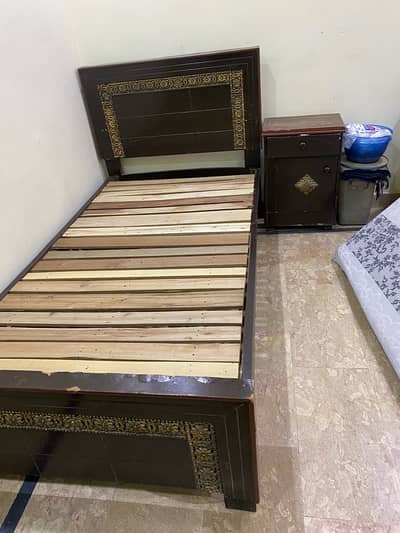 single bed with matress and side table