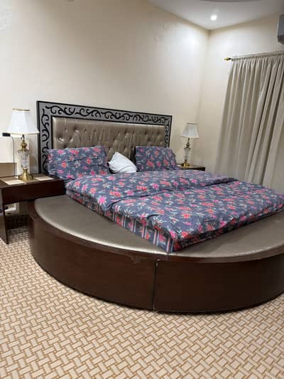 King size round bed with side tables along dressing table