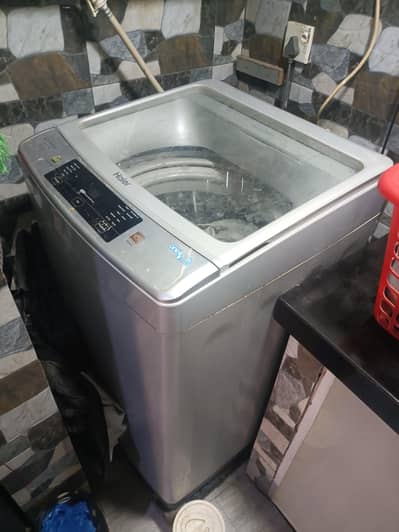 Haier 9 kg top loader washing machine + metal stand + cover