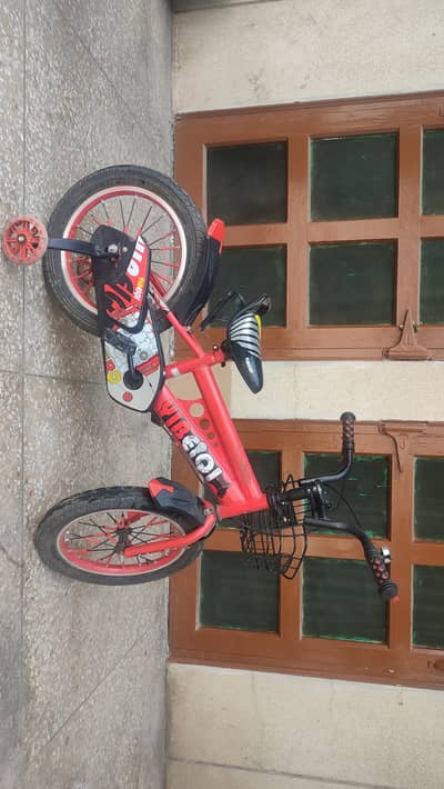 Kids cycle in great condition. Red colour and training wheels.