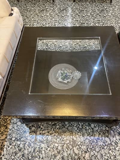 Dark brown table made of glass and wood