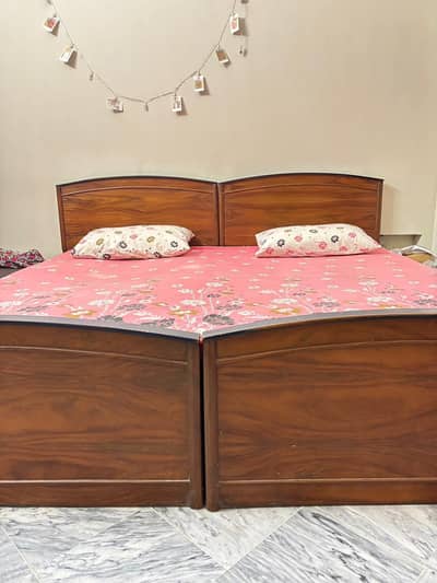 Two Single Wooden Beds