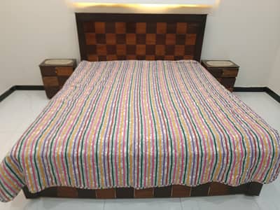 Double Bed with mattress and side tables.
