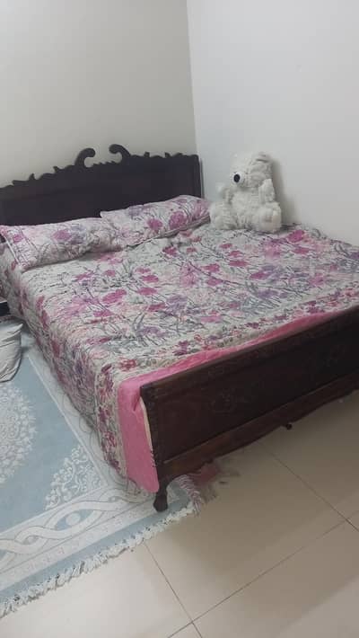 wooden bed with mattress