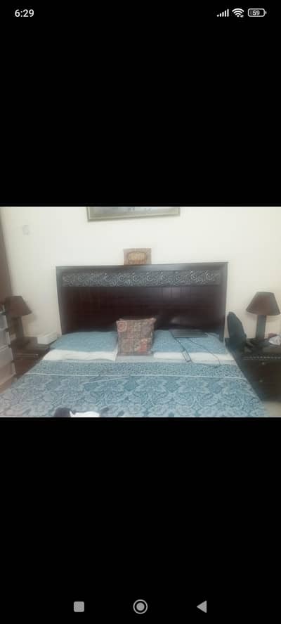 wooden bed with side tables and wardrobe