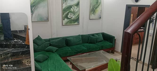 L shape sofa with table and three paintings