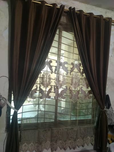 pair of velvet brown curtains with one palachi curtain