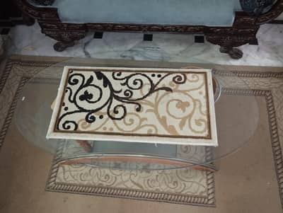 modern oval glass coffee table with a stylish wood and metal design.