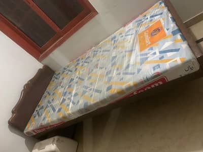 Bed with mattress,cupboard and table