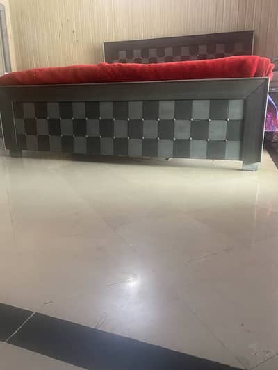 A complete queen size bed set in grey & black color.