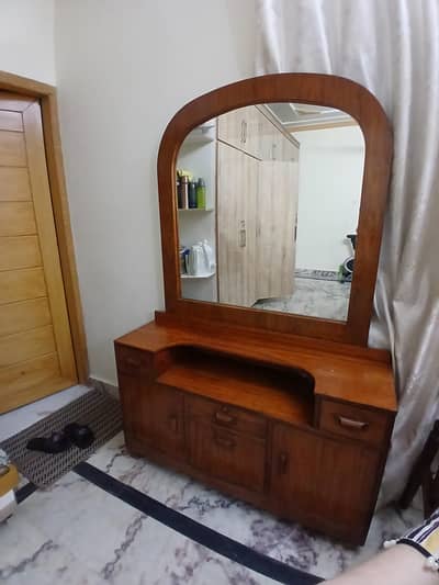Solid wooden dressing tables with large mirrors.
